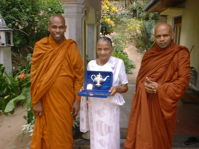 with mother and Teacher is holding the special gift received from th president of Sri Lanka on 17.05.2006.JPG